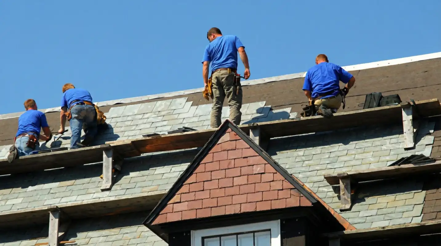 Roof replacement in progress with a team of professional contractors installing new shingles on a residential home in Lincoln, NE