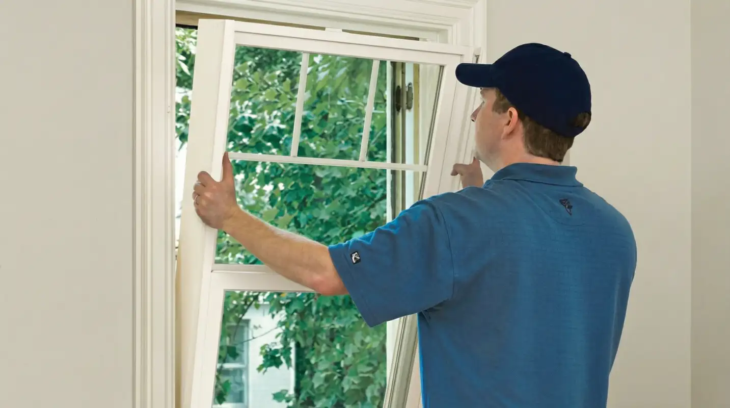 Professional contractors performing a residential window insulation and replacement service in Lincoln, NE